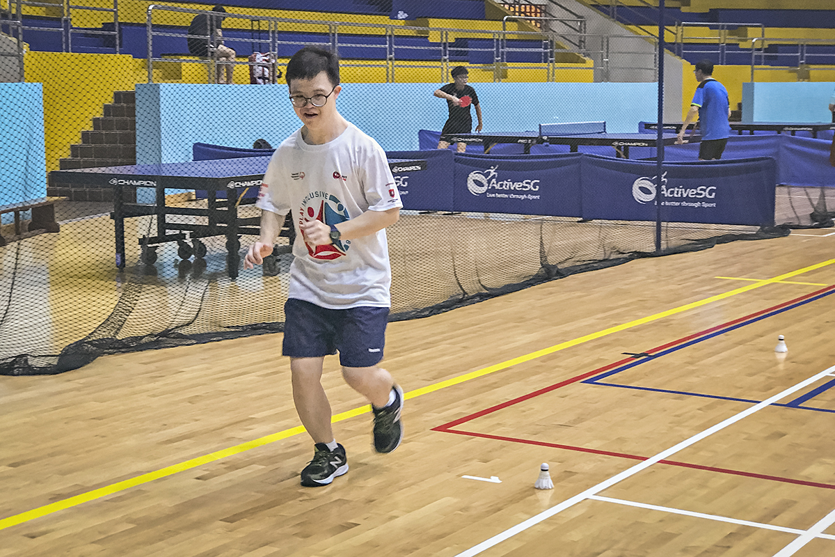 Johannes Cheong, Special Olympics Asia Pacific athlete, running in a badminton court during a practice session.