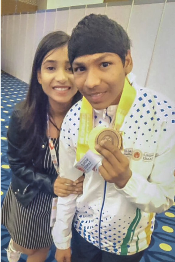 RISHABH (RIGHT) PICTURED HOLDING HIS GOLD MEDAL WITH HIS SISTER SHRUTI (LEFT).