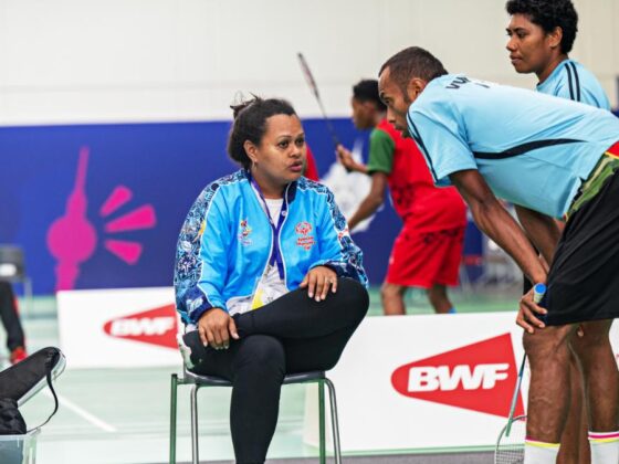 Coach Tagici in conversation with her student.